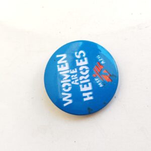 blue pin-back button featuring the text WOMEN ARE HEROES sold by Sweilems in Amman