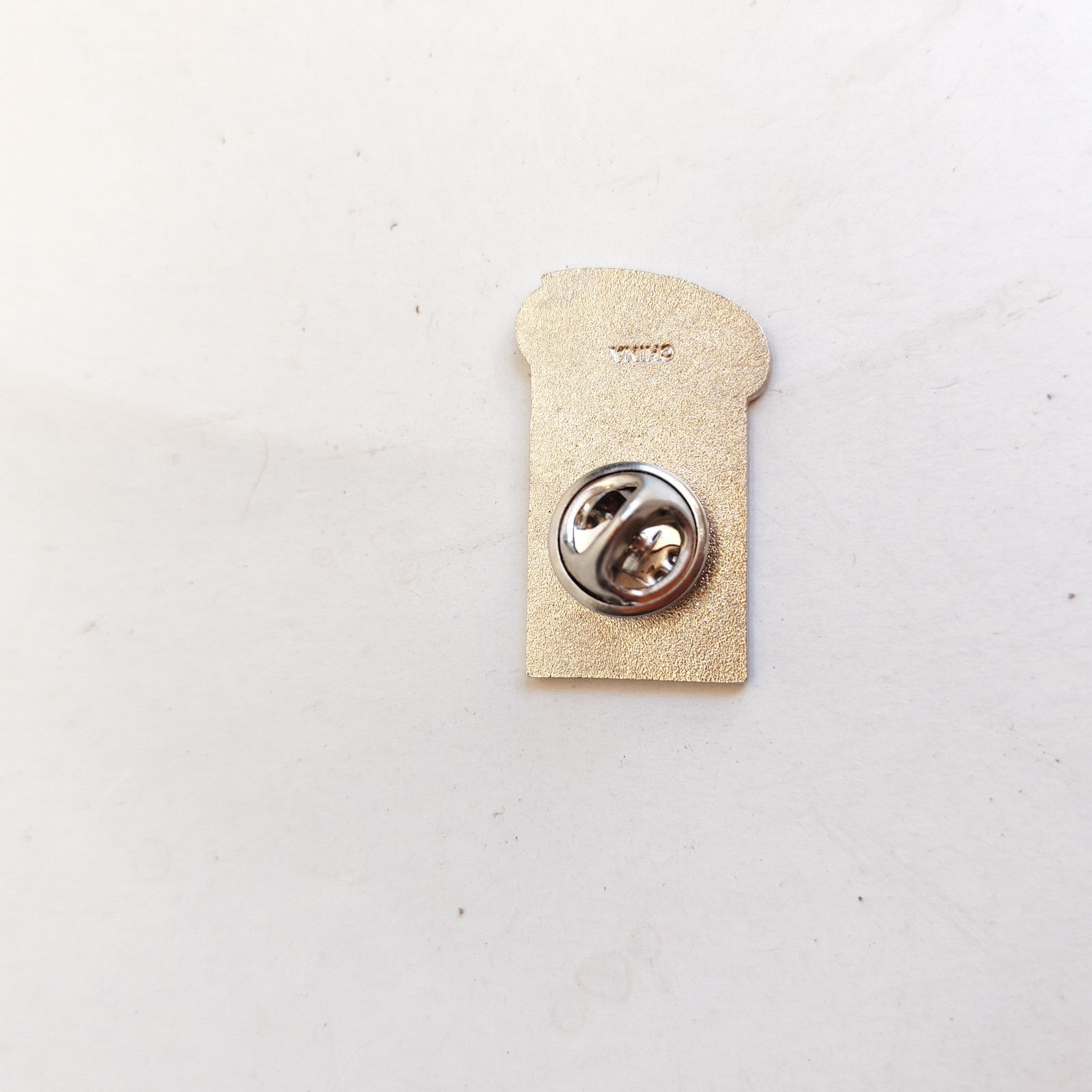 vintage 1999 Special Olympics World Games lapel pin detail photograph