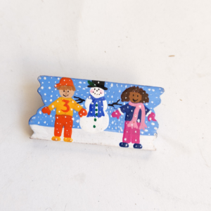 hand-painted wooden block decoration featuring a snowman and children sold by Sweilems in Amman