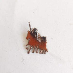 vintage pin depicting Don Quixote and Sancho Panza on horseback sold by Sweilems in Amman