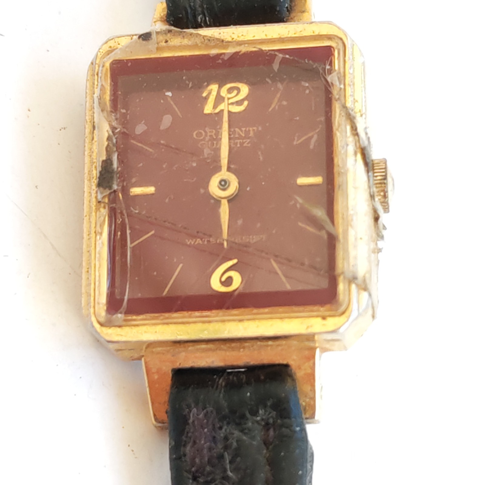 vintage gold-tone Orient Quartz rectangular watch detail photograph