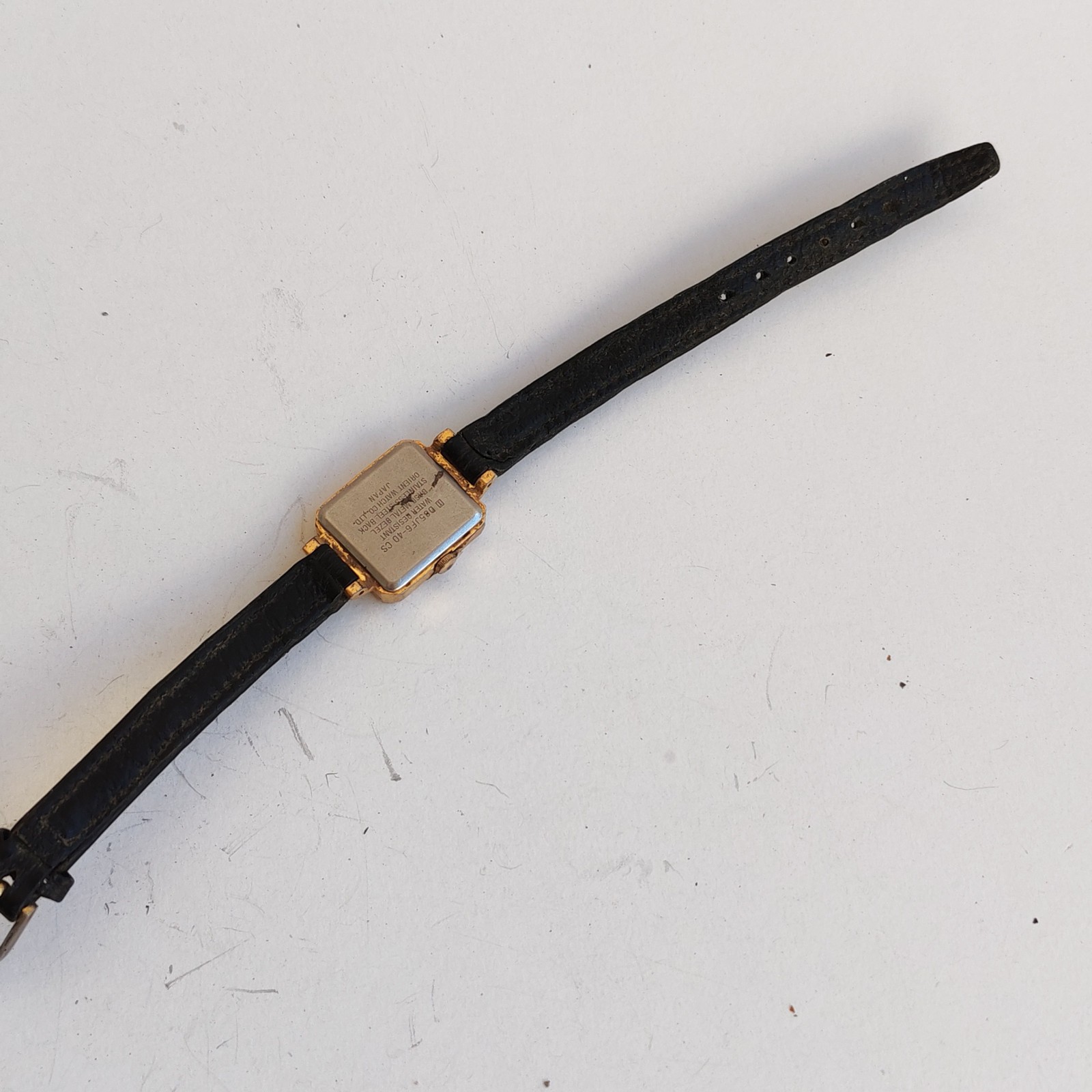 vintage gold-tone Orient Quartz rectangular watch detail photograph