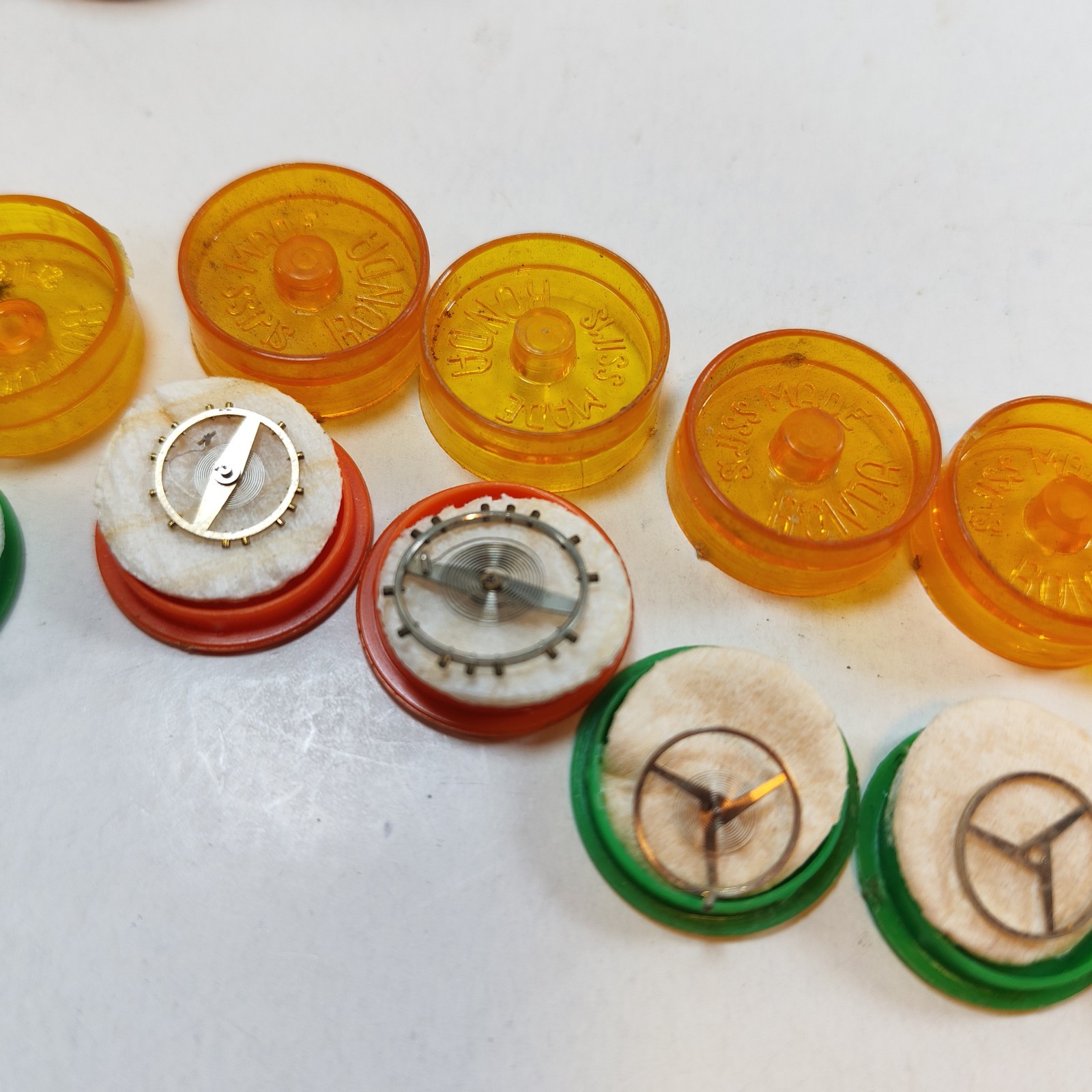 Vintage Small Watch Parts Storage Tin Lot and some watch parts lot detail photograph