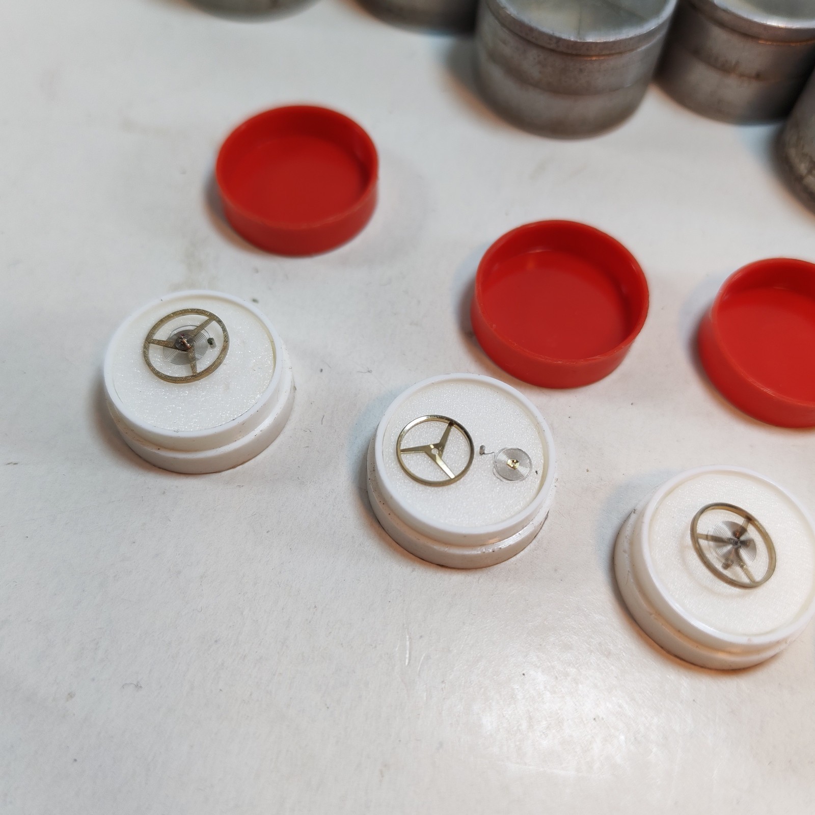 Vintage Small Watch Parts Storage Tin Lot and some watch parts lot detail photograph