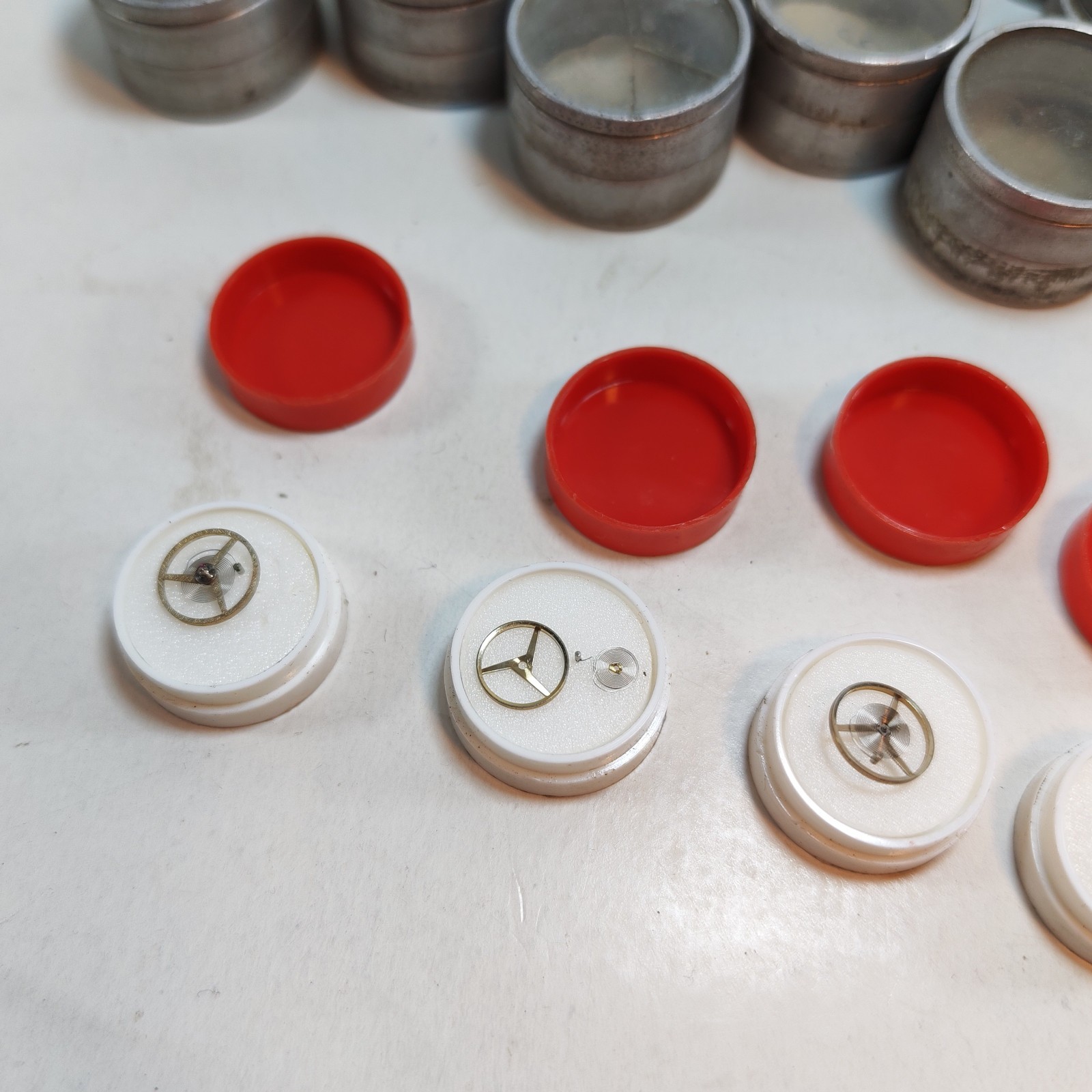 Vintage Small Watch Parts Storage Tin Lot and some watch parts lot detail photograph