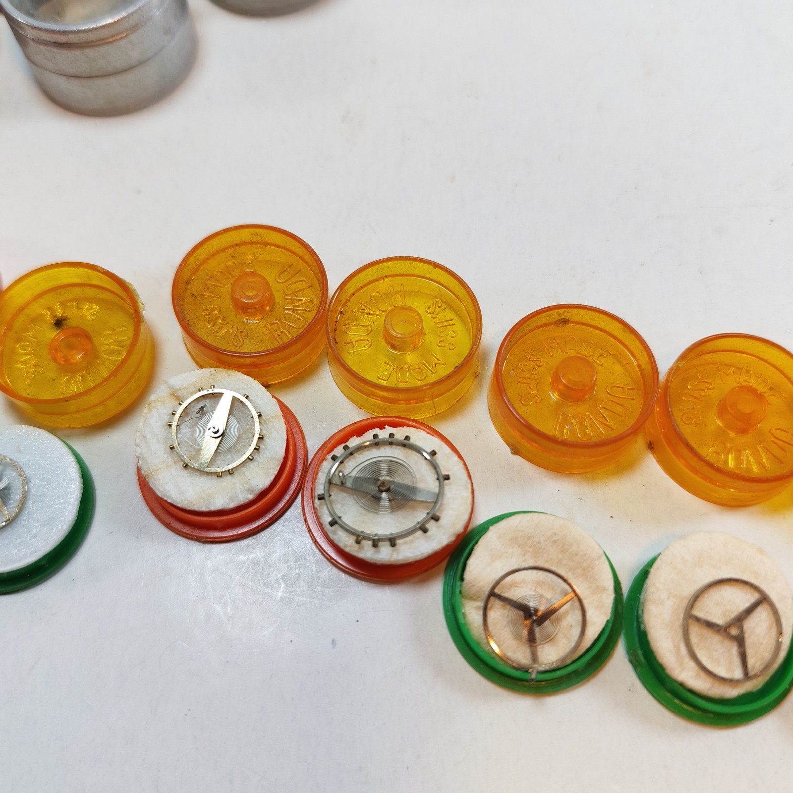 Vintage Small Watch Parts Storage Tin Lot and some watch parts lot detail photograph