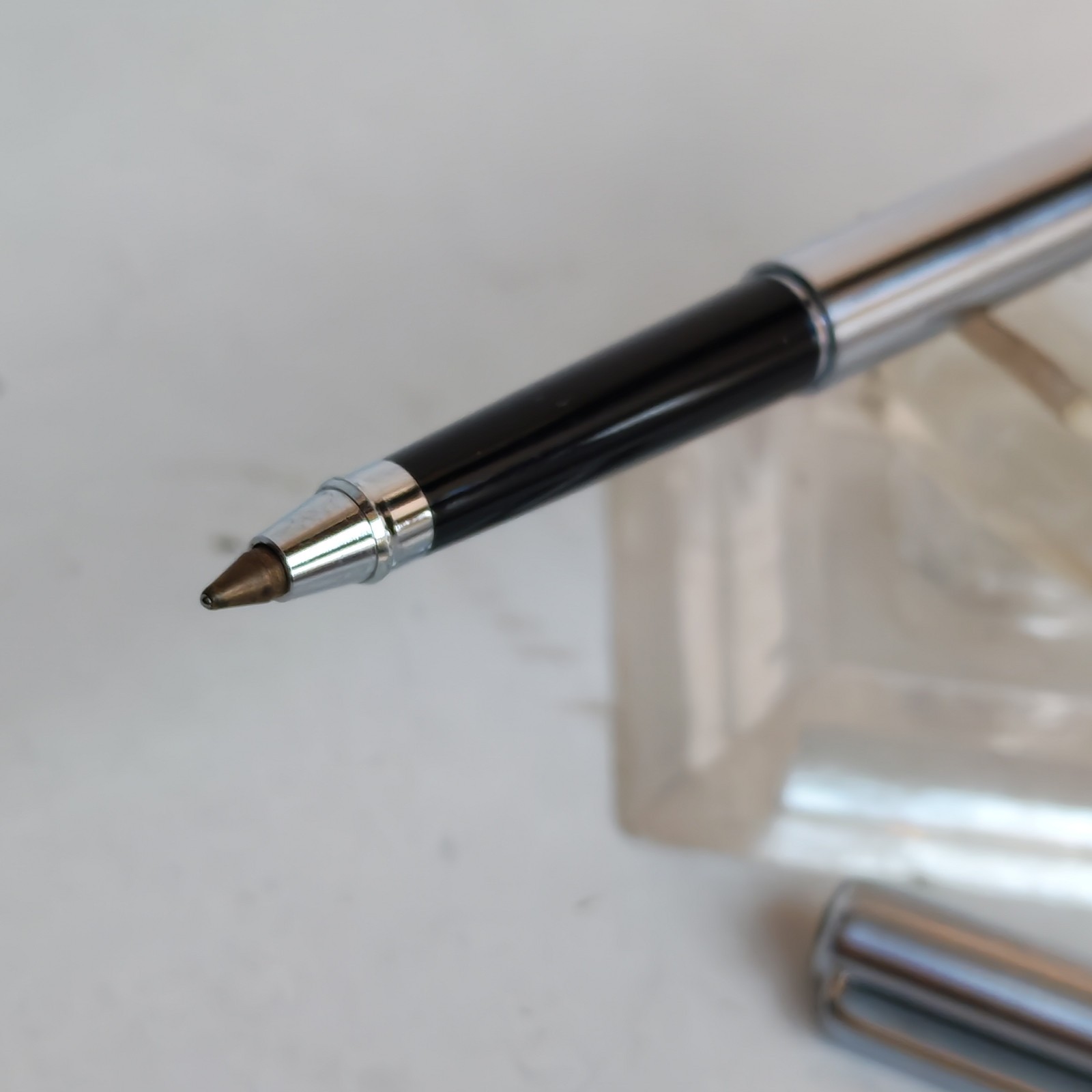 Vintage slim ballpoint pen with the letter B as logo detail photograph