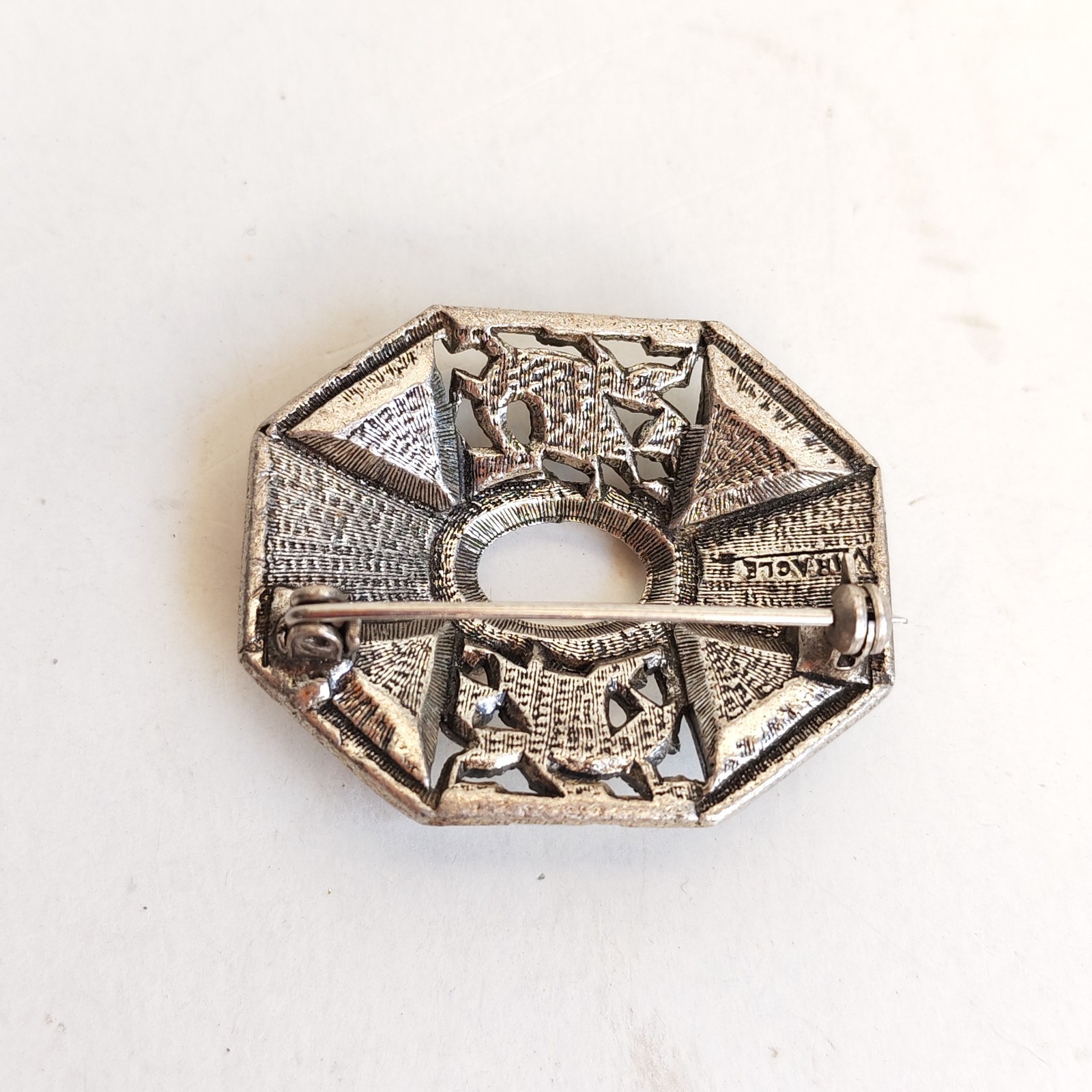Welsh Heraldic Dragon decorating a brooch with faux amethyst missing center st detail photograph