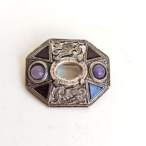 Welsh Heraldic Dragon decorating a brooch with faux amethyst missing center st sold by Sweilems in Amman