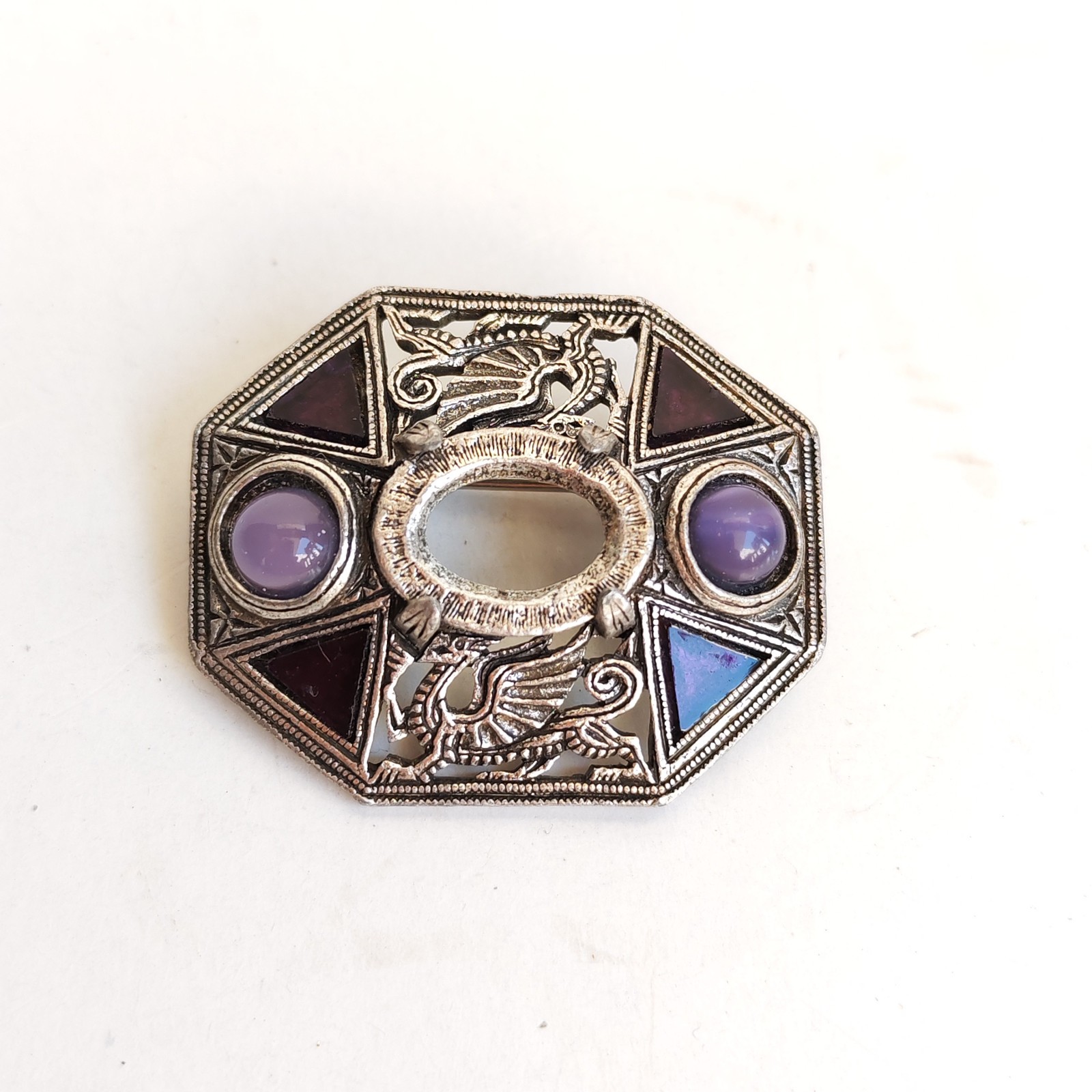 Welsh Heraldic Dragon decorating a brooch with faux amethyst missing center st sold by Sweilems in Amman